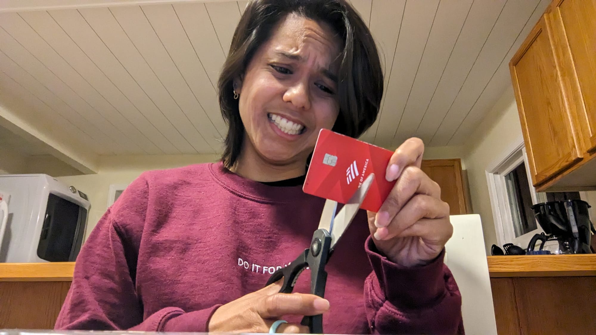 jemellee has a pair scissors about to cut her bank card in half