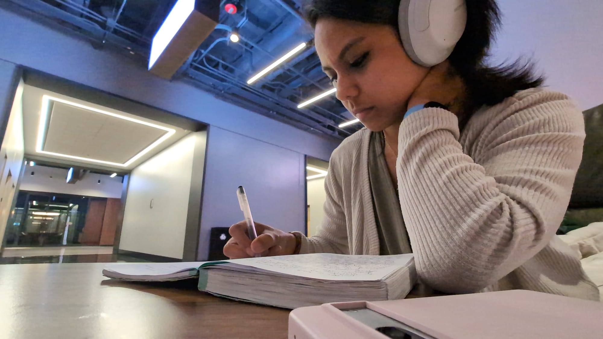 jemellee is has her sony headphones on while journaling in the last few pages of her journal